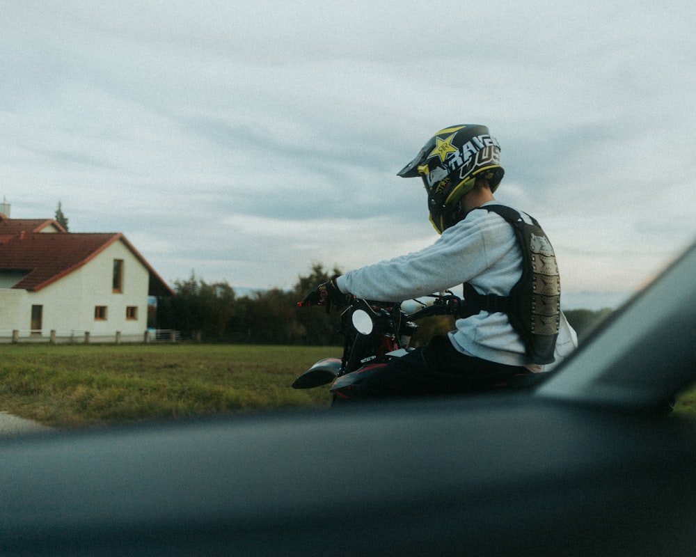 a man riding a motorcycle down a rural road