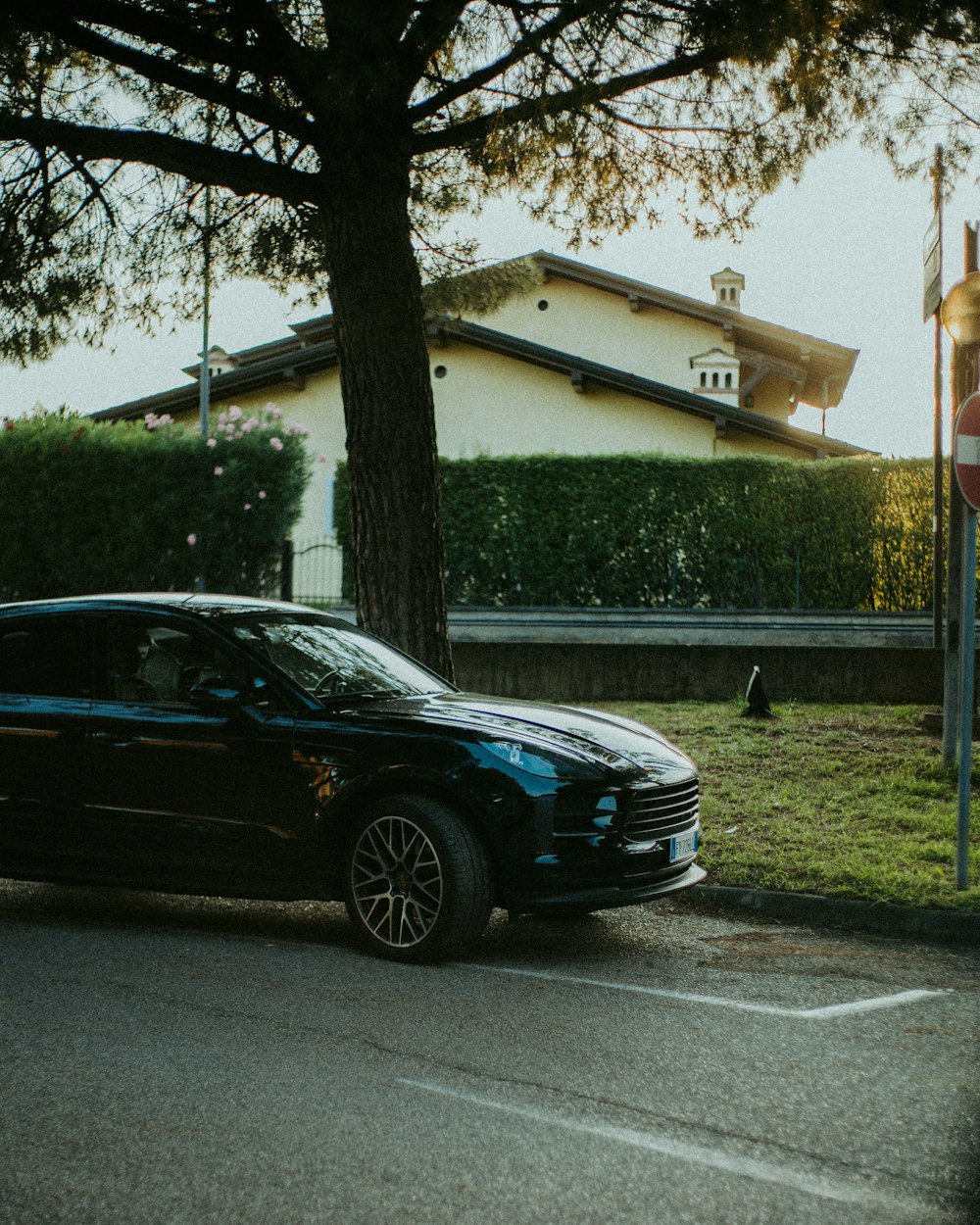 a black car parked on the side of the road