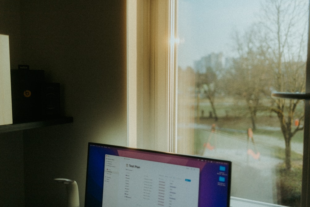 a laptop computer sitting on top of a desk