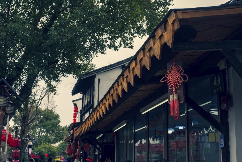 a store front with decorations hanging from it's roof