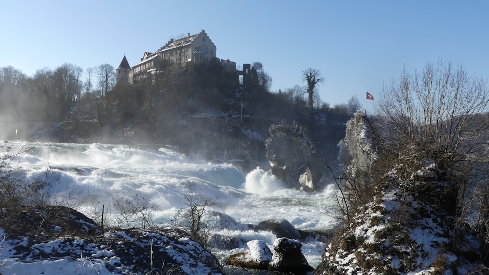 a castle on top of a hill in the middle of a river