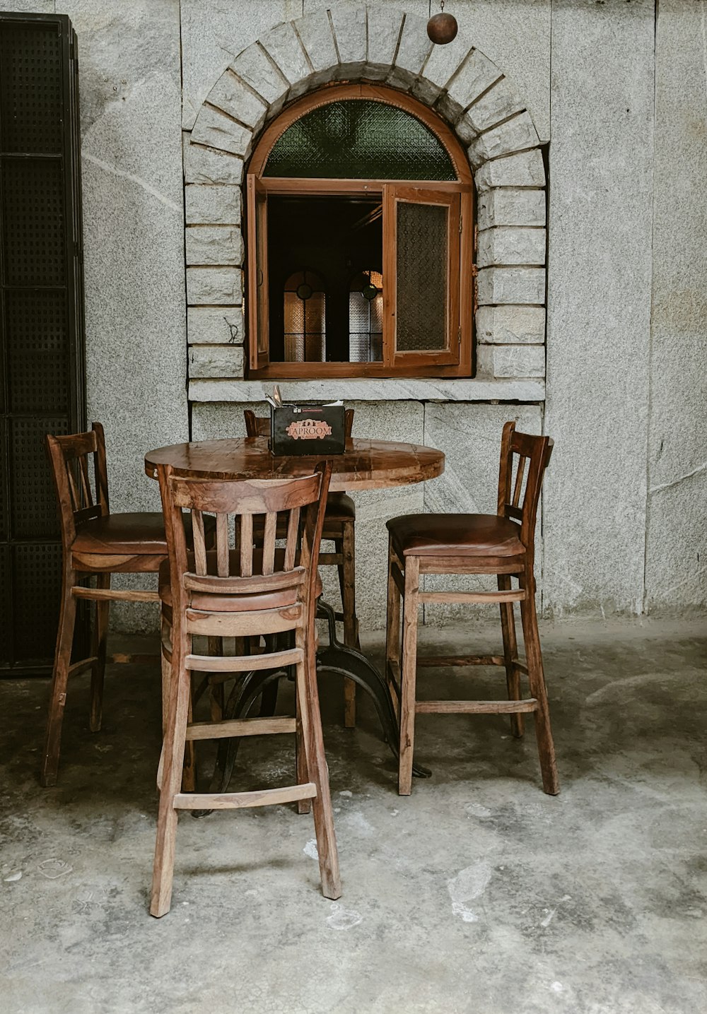 a table and chairs in front of a window