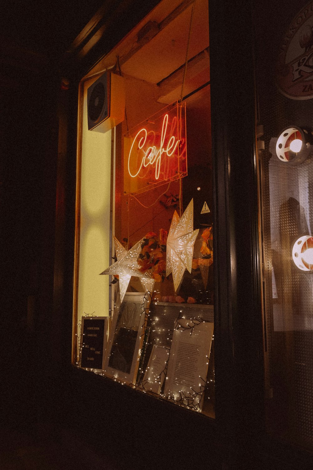 a coffee shop with a neon sign in the window