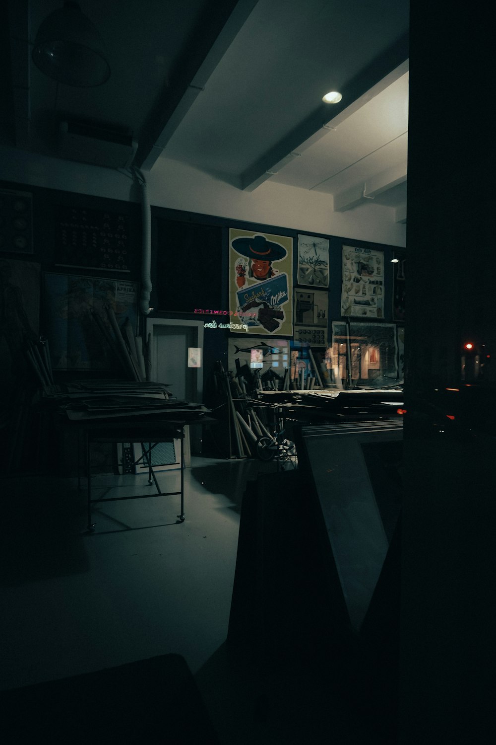 a dark room with a lot of posters on the wall