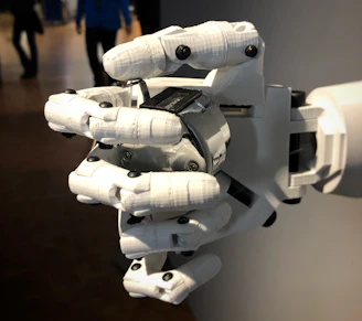 a robotic hand that is holding a laptop