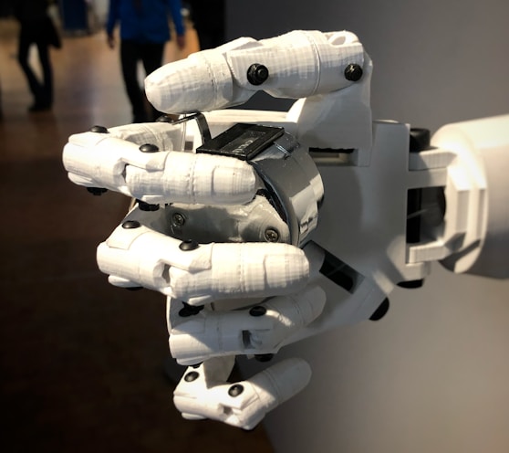 a robotic hand that is holding a laptop