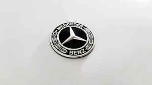 a mercedes benz emblem on a white car