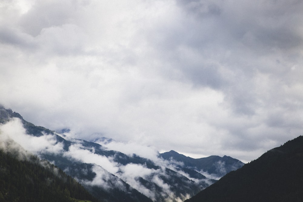 a view of a mountain range with clouds in the sky