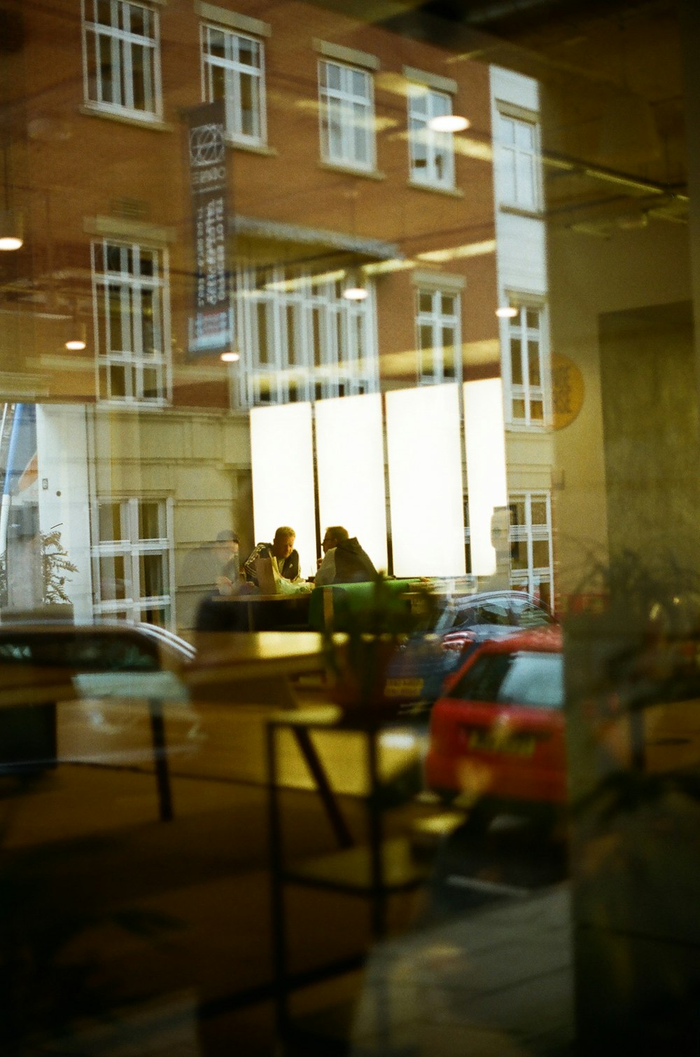 a couple of people sitting at a table in front of a building