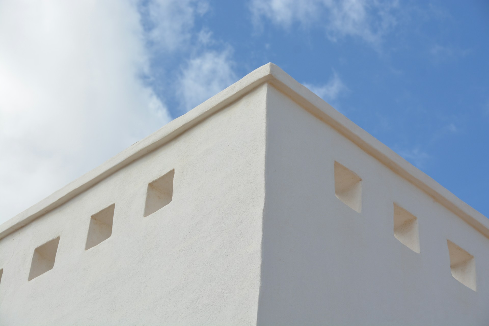 a white building with a blue sky in the background