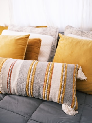 a bed topped with lots of pillows and blankets