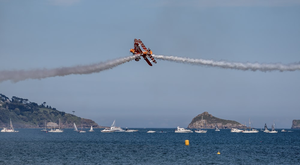 a small plane flying over a body of water