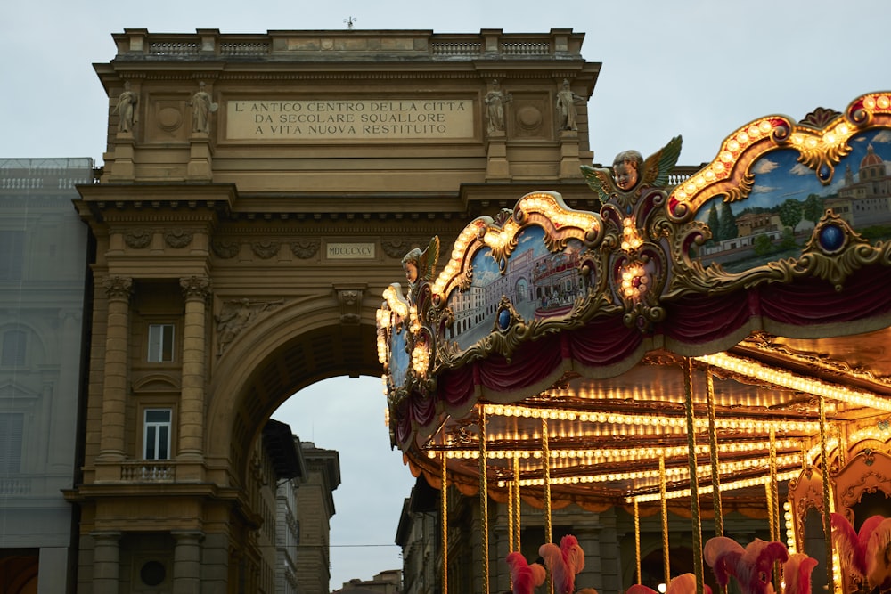 a merry go round in front of a tall building