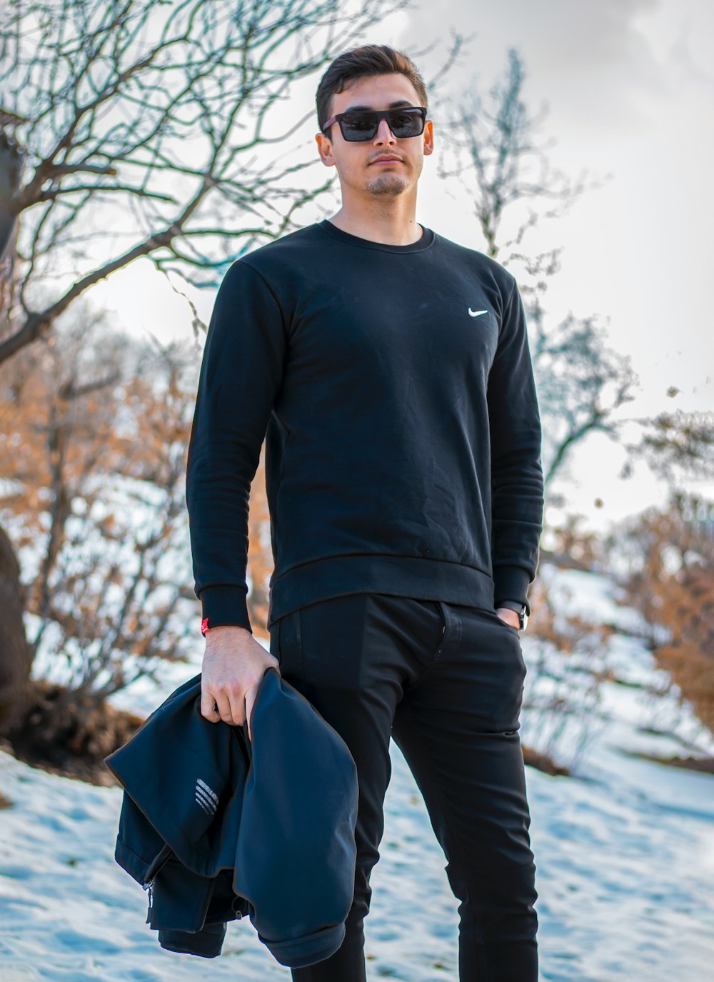 a man in a black shirt and black pants