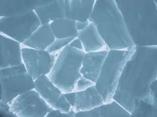 a close up view of ice cubes in the snow