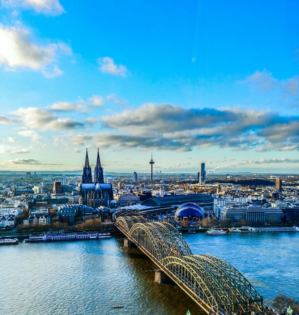 a bridge over a river with a city in the background