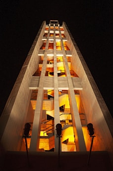 a tall building lit up at night time