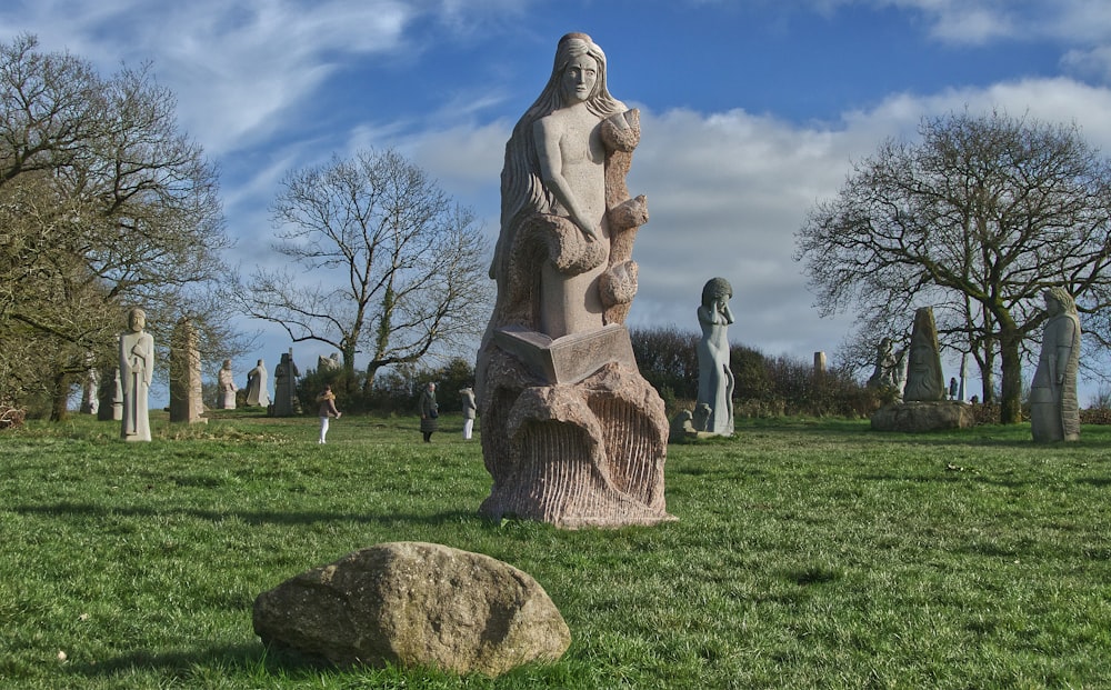 a statue of a woman holding a baby in a cemetery