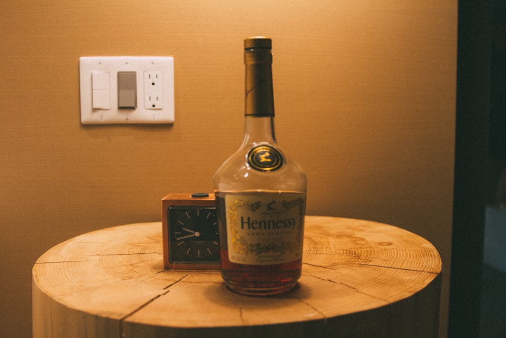 a bottle of henness gin on a wooden table
