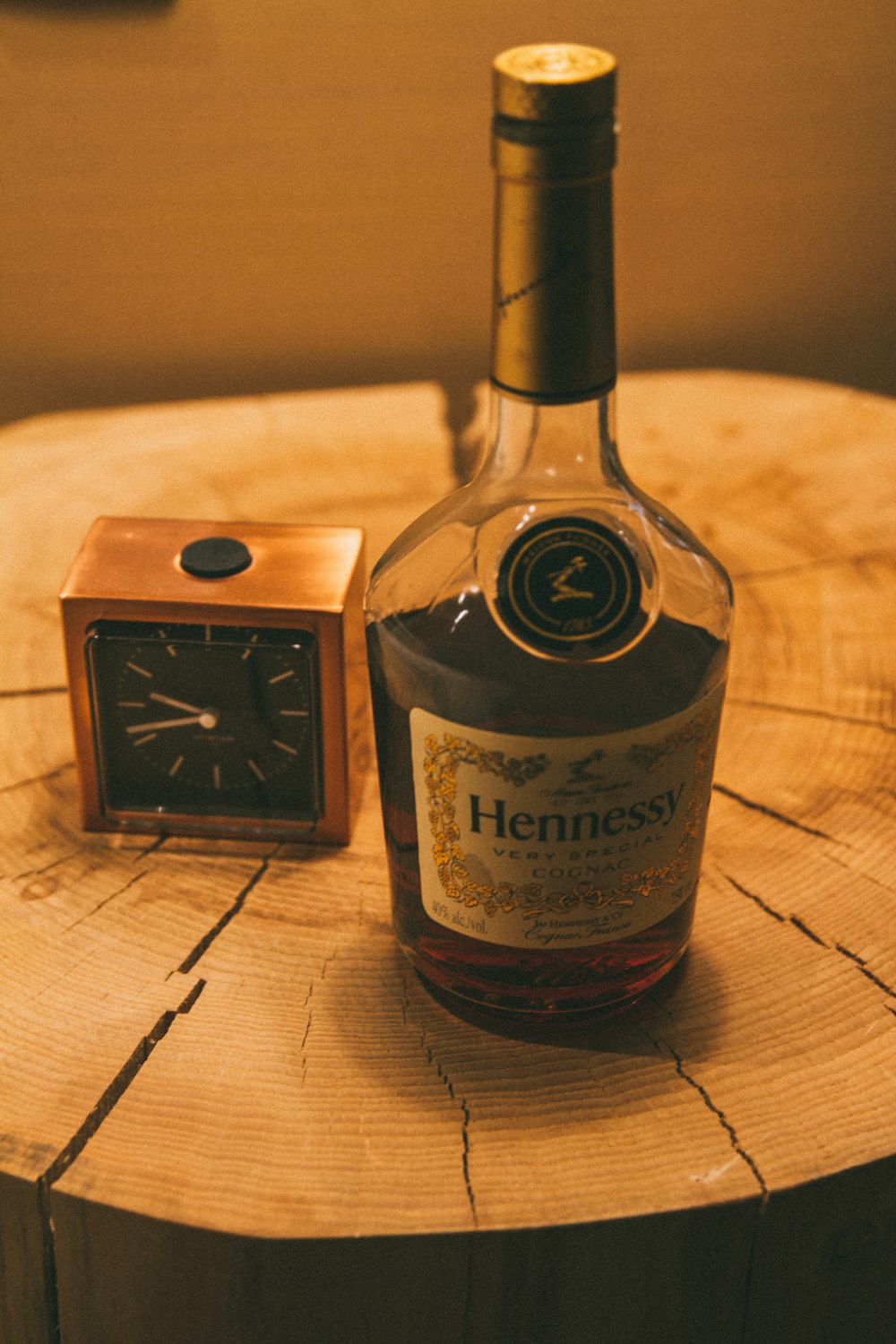 a bottle of henness sitting on top of a wooden table