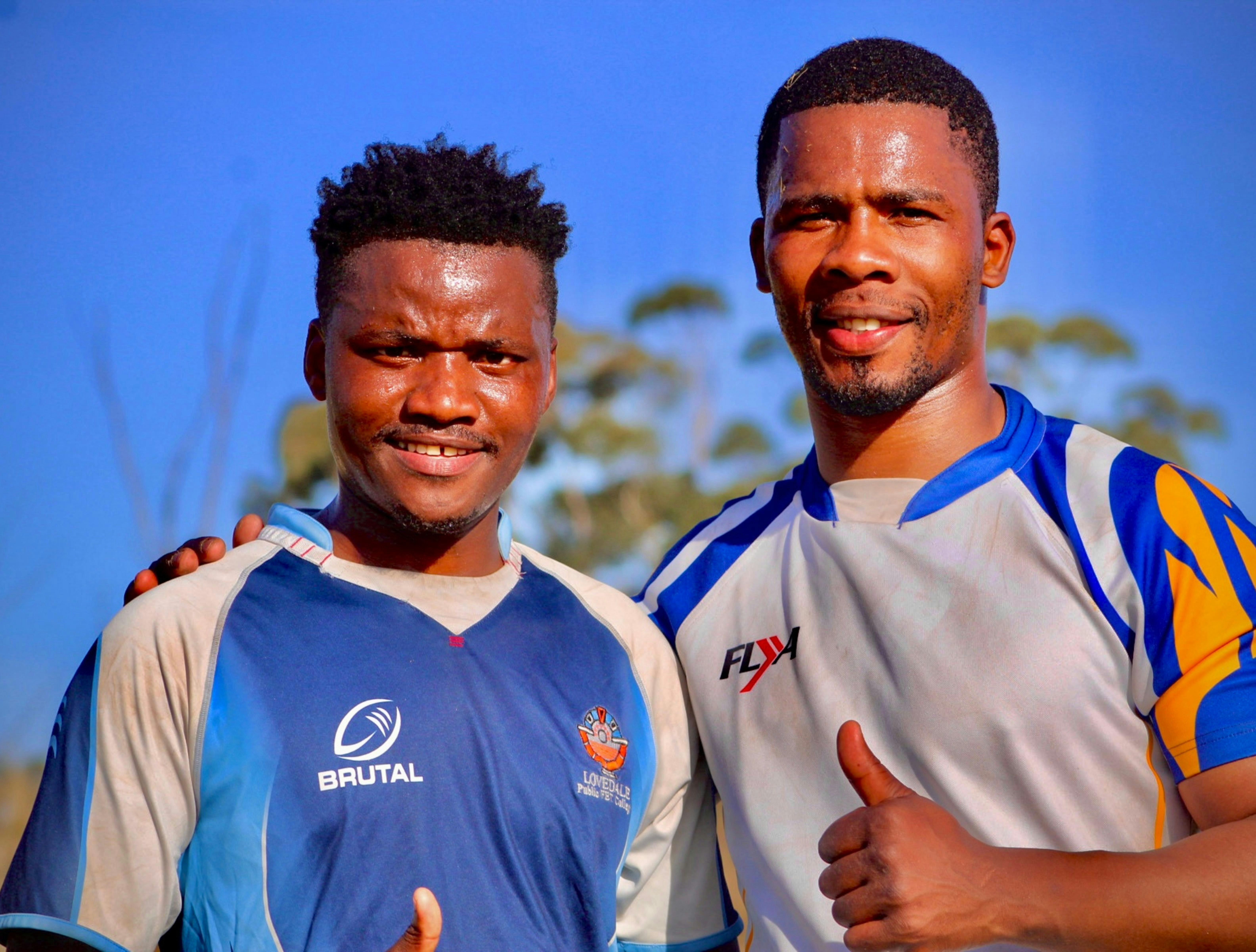 a couple of men standing next to each other