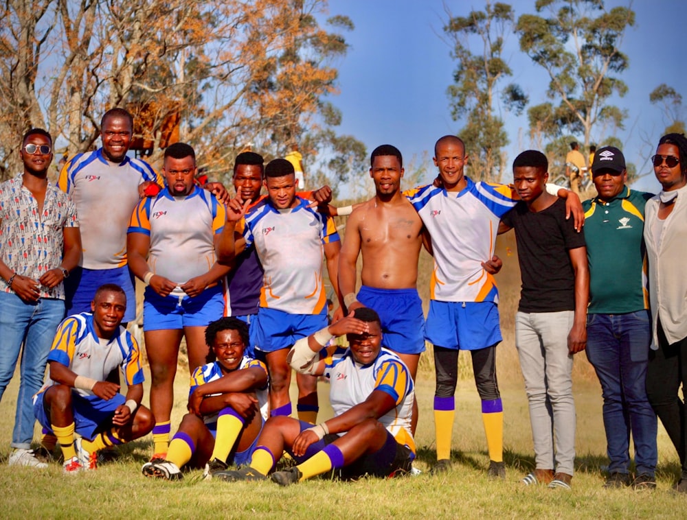 a group of men standing next to each other on a field