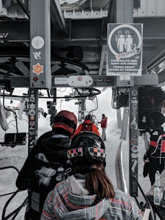  people riding a ski lift