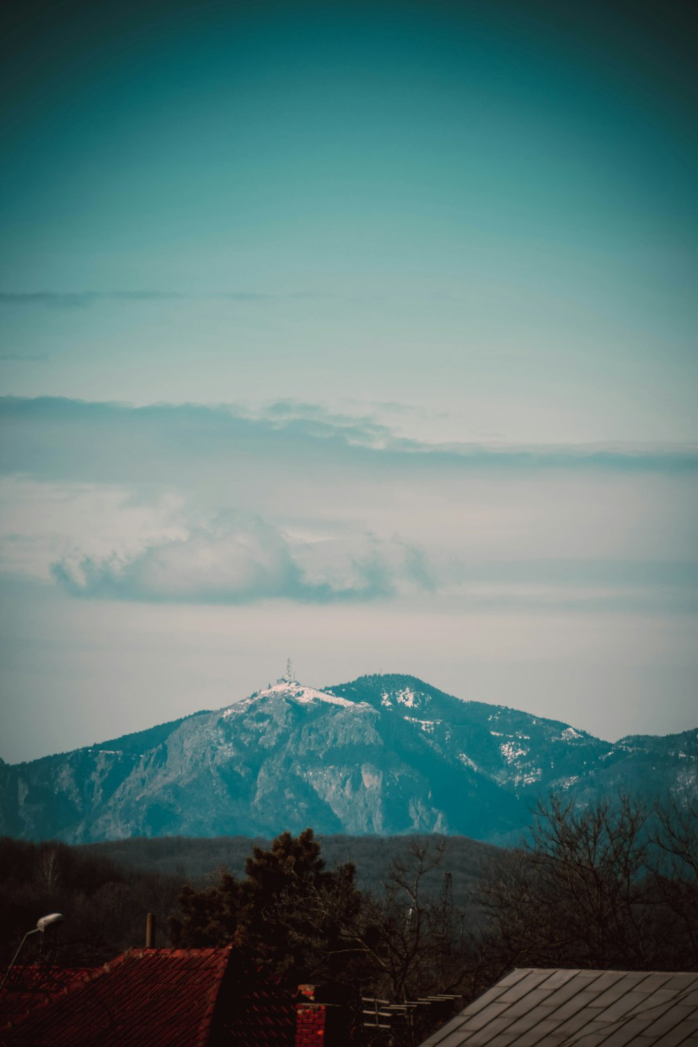 a view of a mountain range from a rooftop