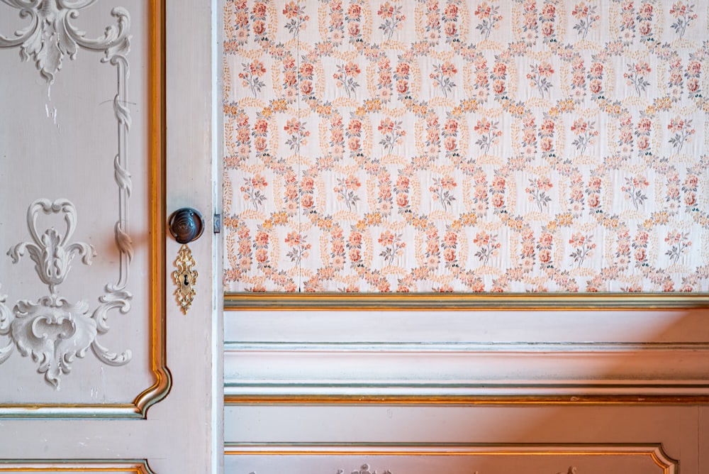 a close up of a door with a wall paper