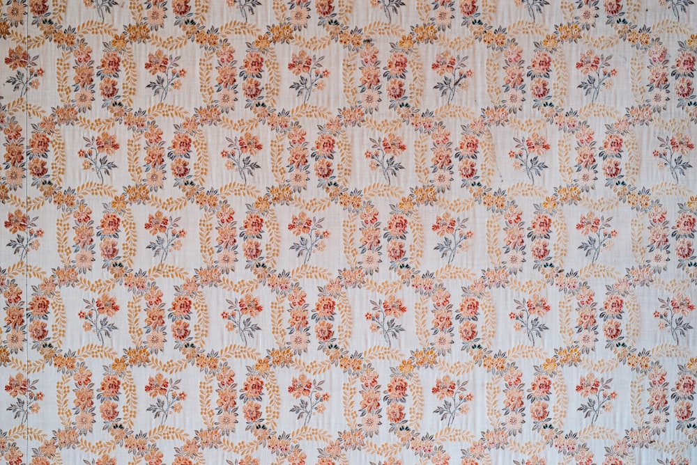 a floral wallpaper with orange and grey flowers