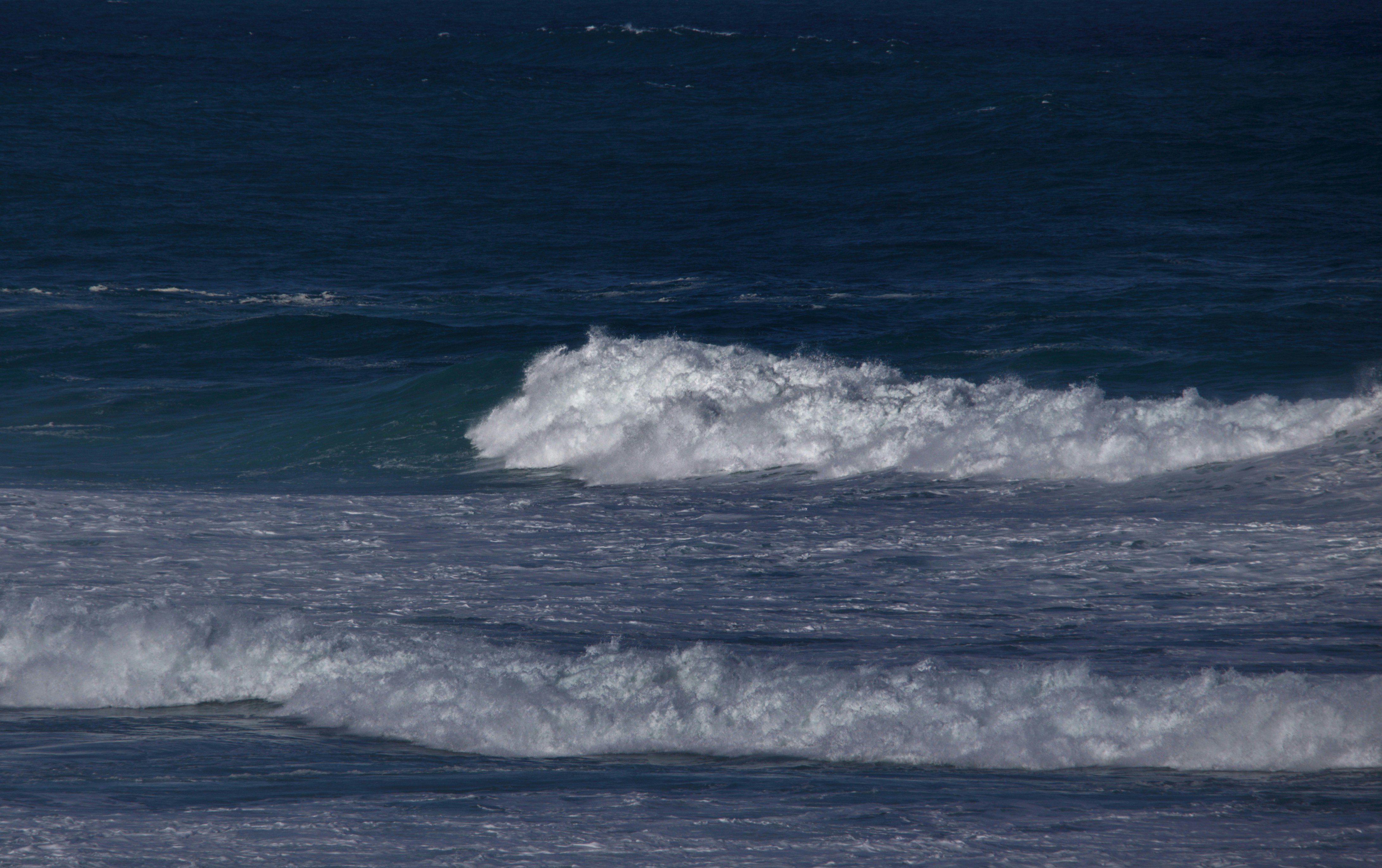 a man riding a wave on top of a surfboard