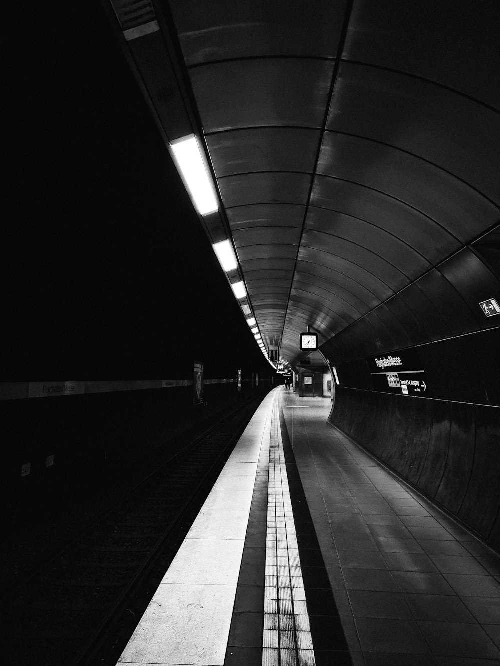 a black and white photo of a subway station