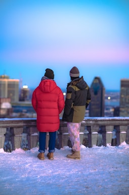 a couple of people that are standing in the snow
