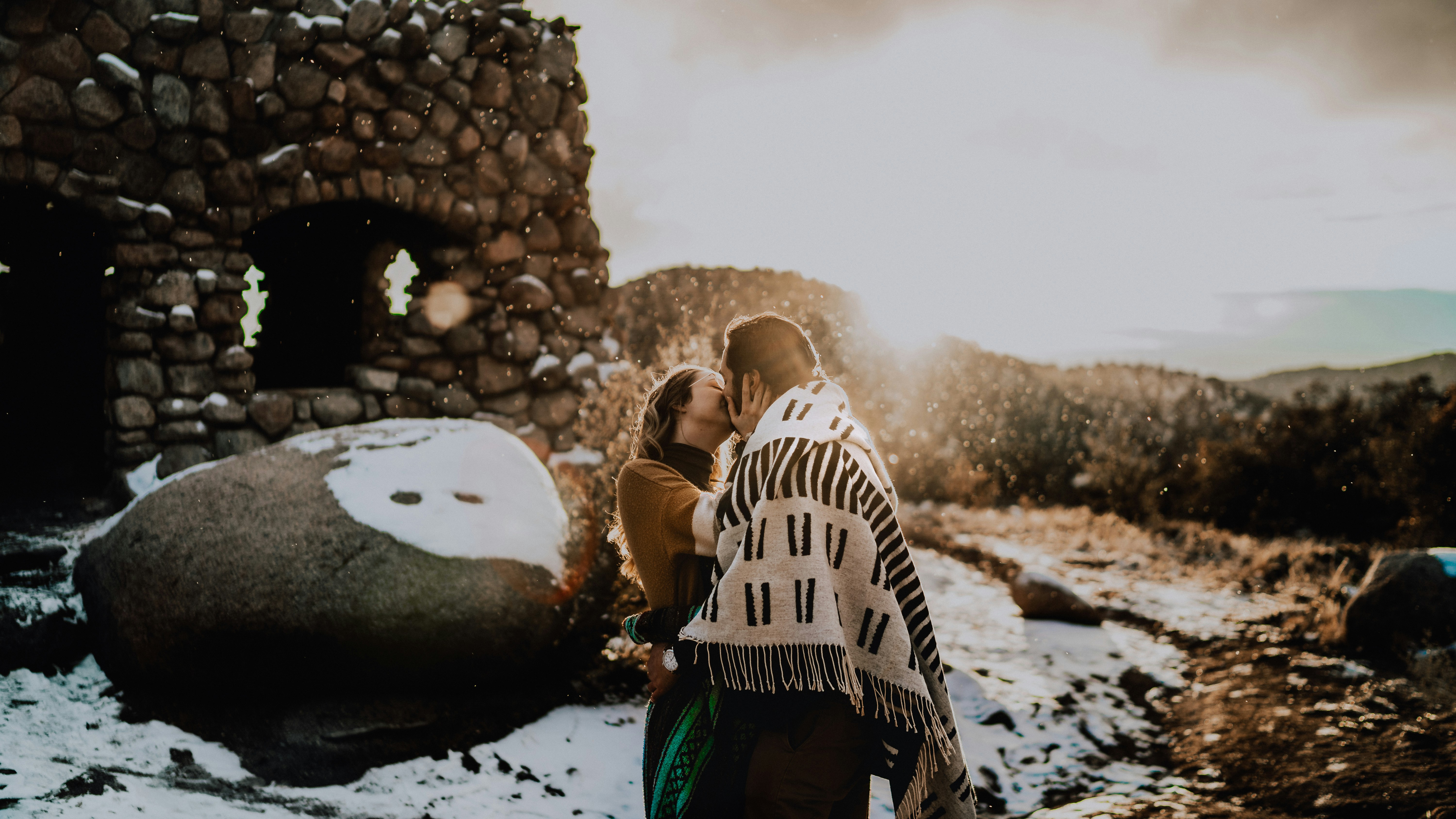 a man and a woman standing next to each other in the snow