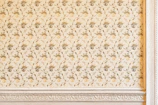 An intricate floral pattern printed delicately on a residential exterior wall.