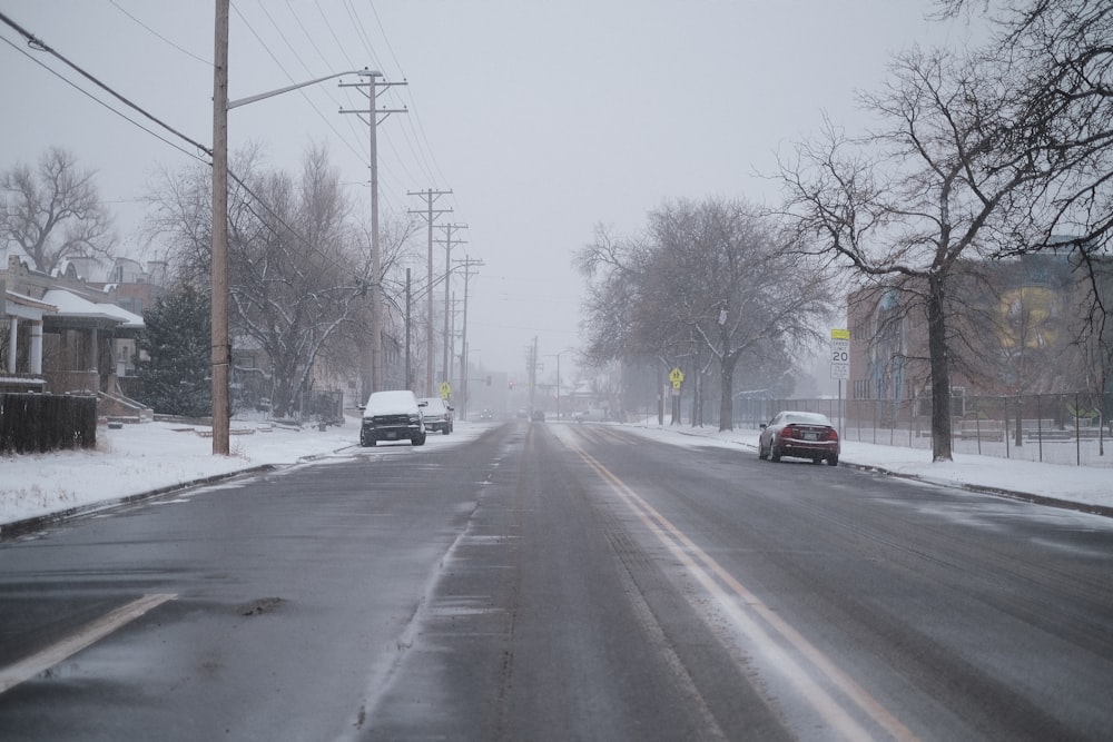 a car driving down a snow covered street