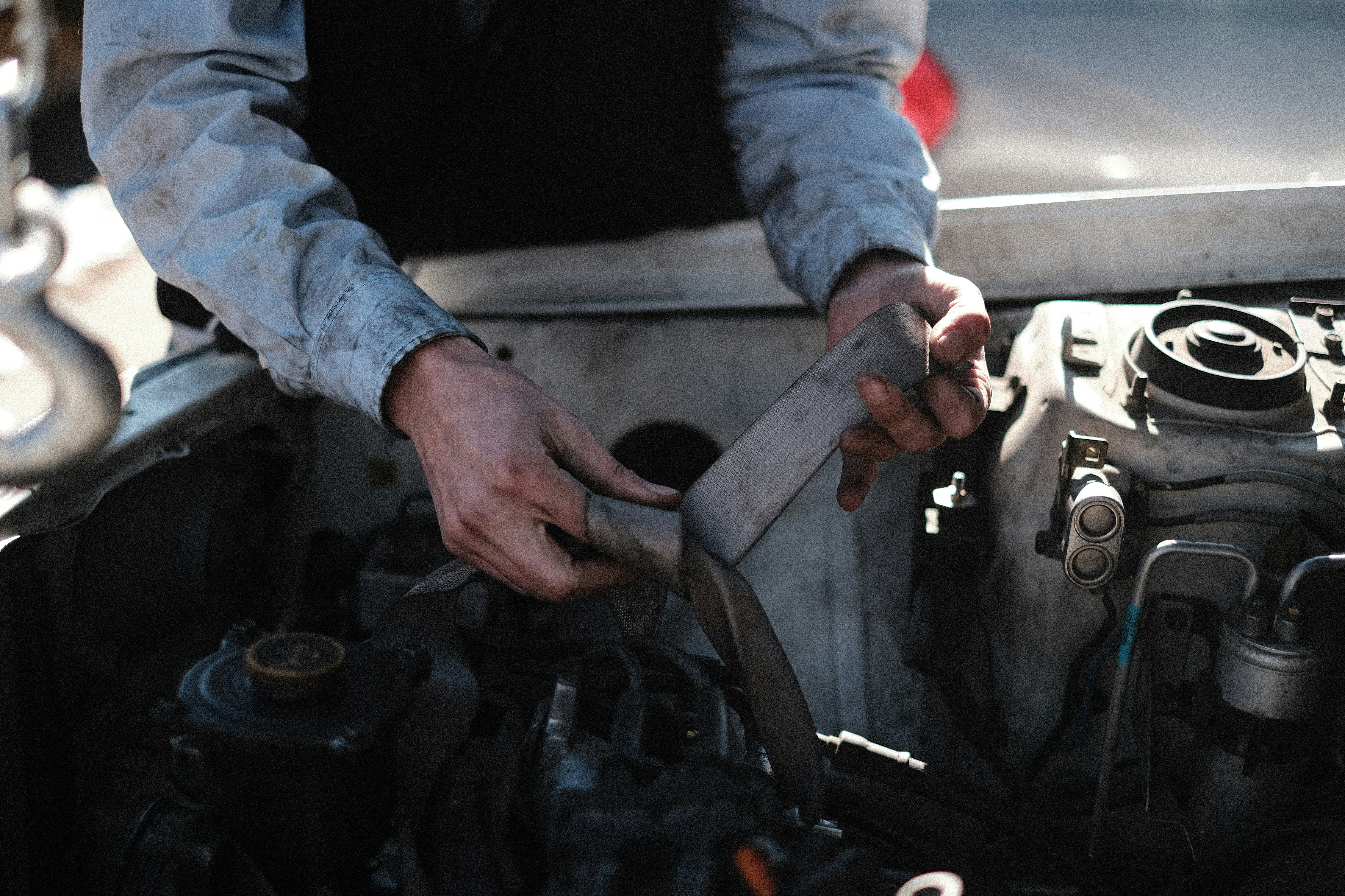 Technician inspecting an electric car battery in a service bay