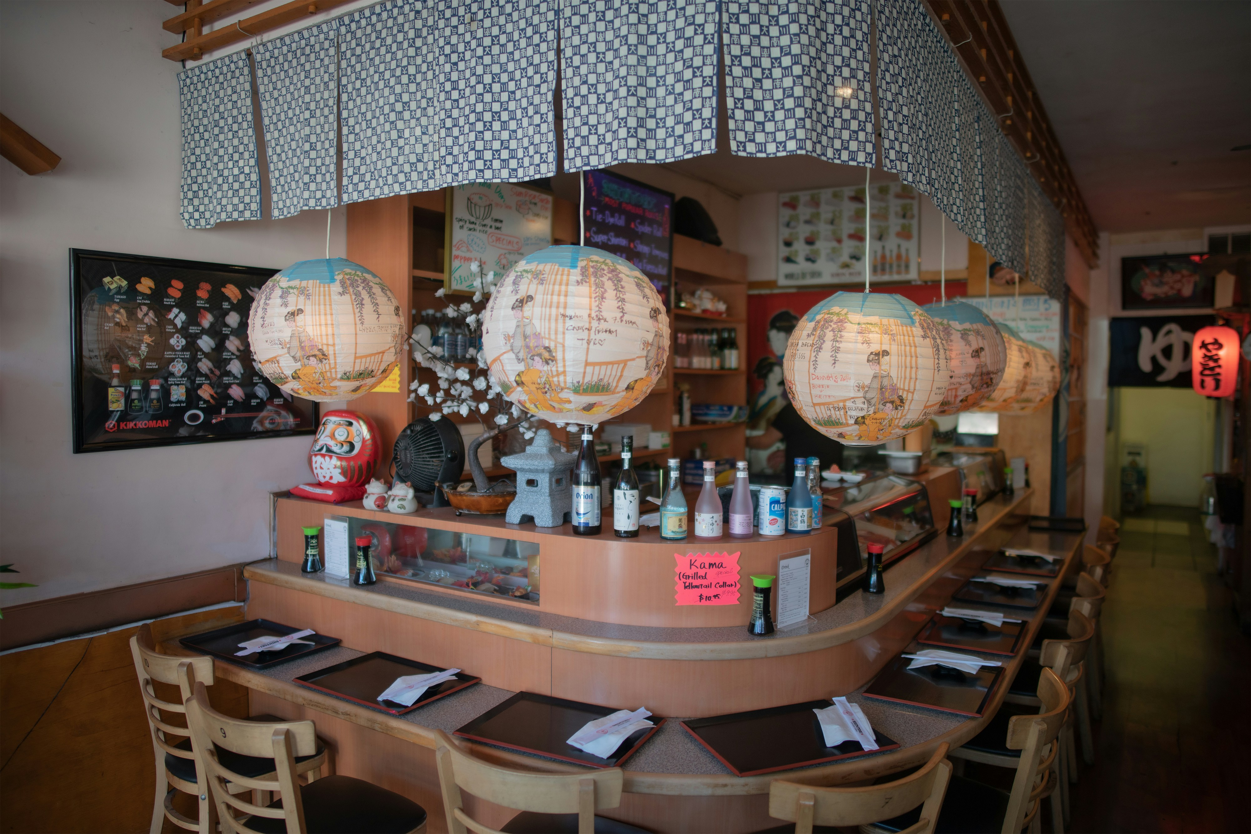 Modern Japanese restaurant with robata grill, sushi counter, and ambient lighting