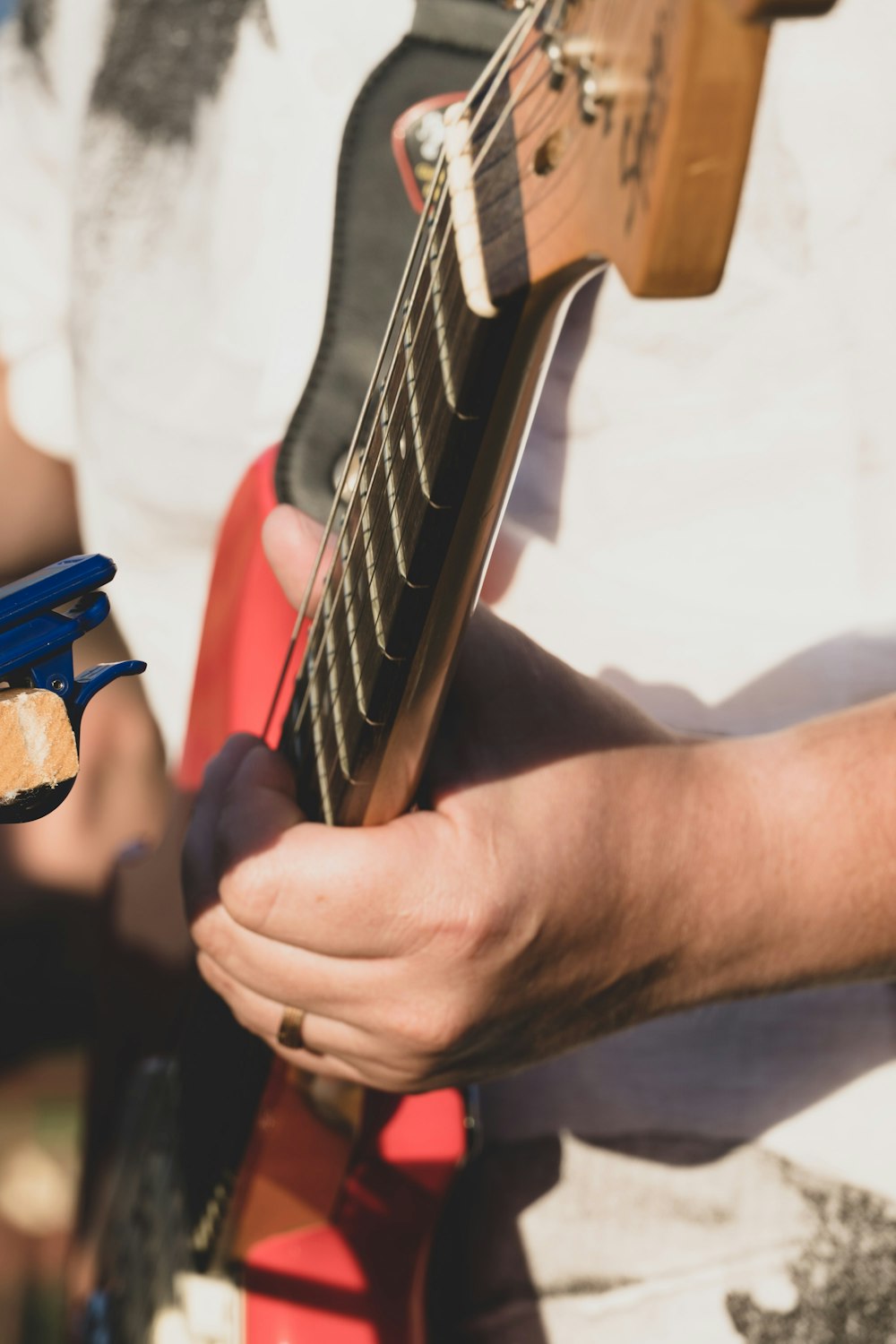 a person holding a guitar in their hand