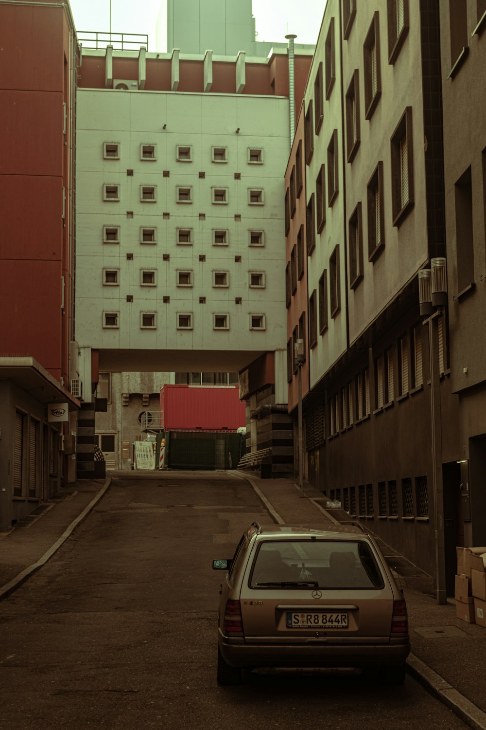 a car parked in an alley between two buildings