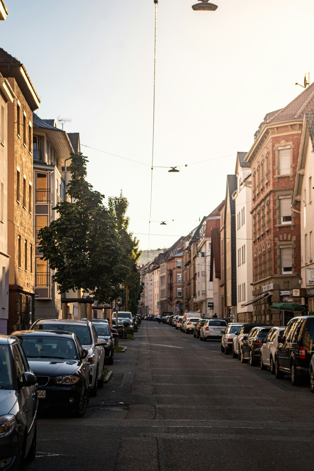 a row of parked cars on a city street