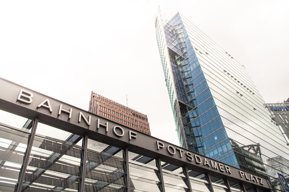 a tall glass building next to a tall glass building