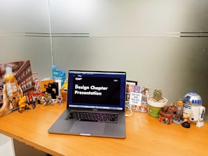 a laptop computer sitting on top of a wooden desk