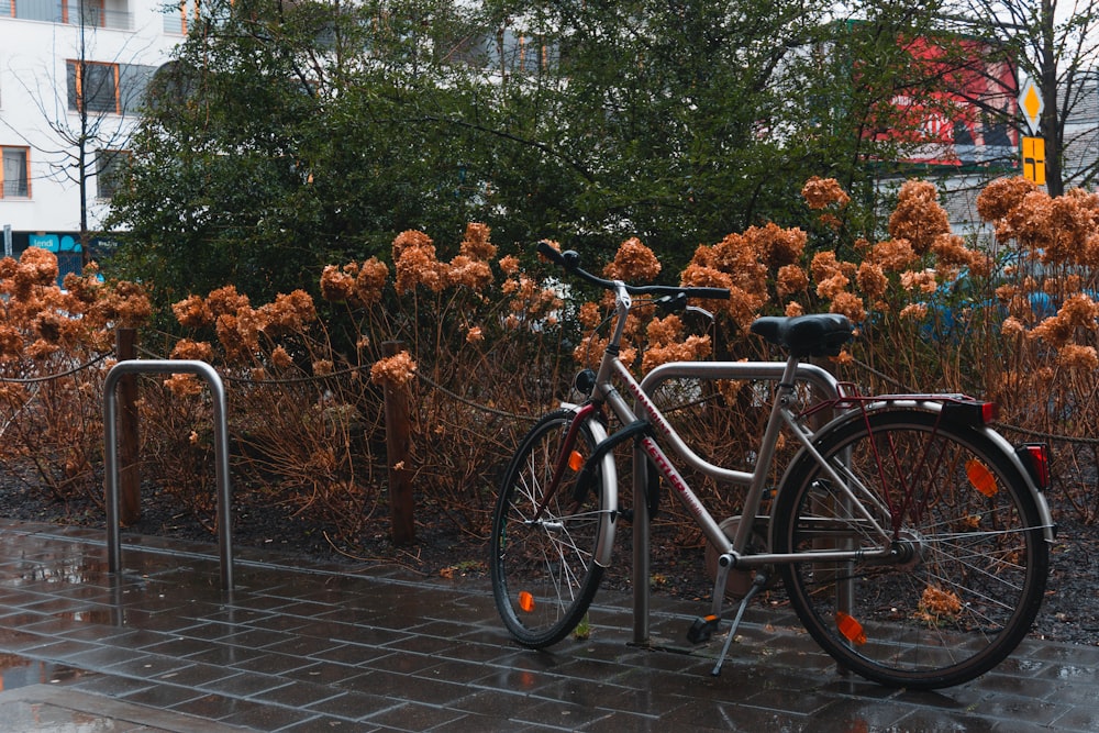 a bicycle parked next to a metal fence