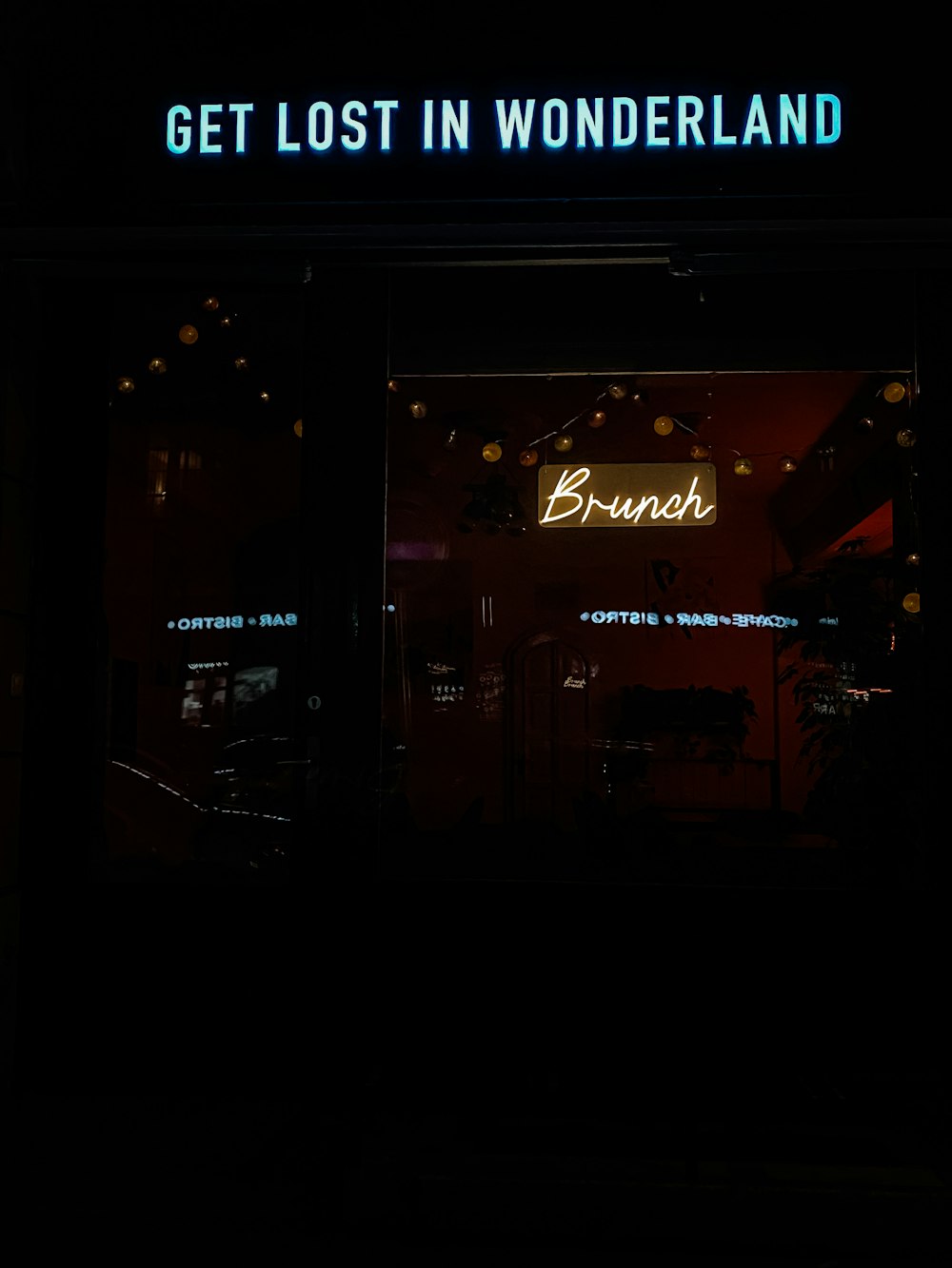 a store front with a neon sign in the window