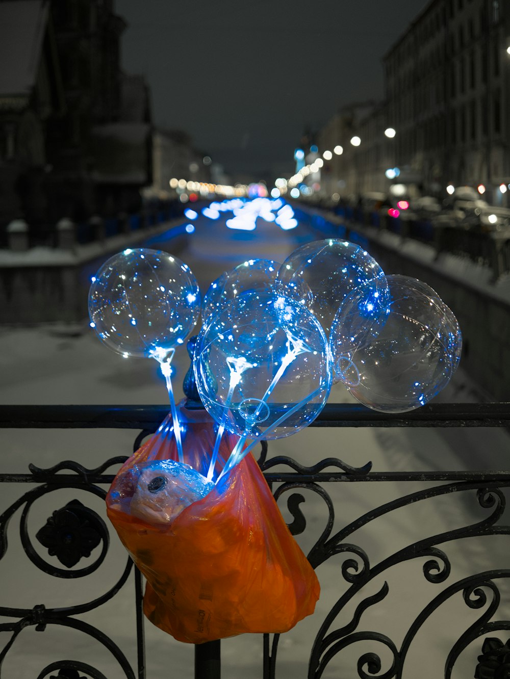 a bunch of bubbles sitting on top of a metal fence