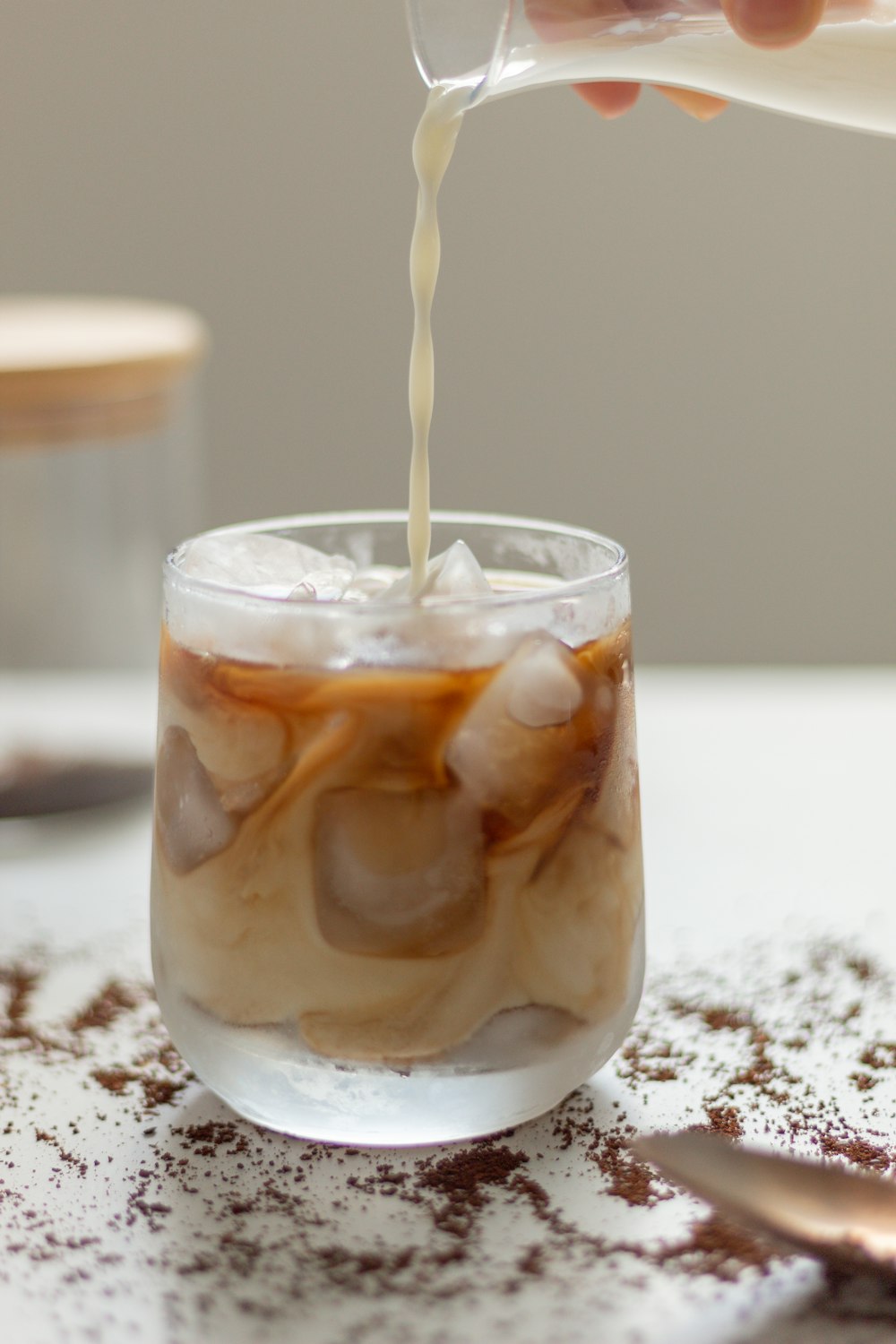 a person pouring a beverage into a glass