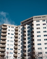 a tall white building with balconies and balconies