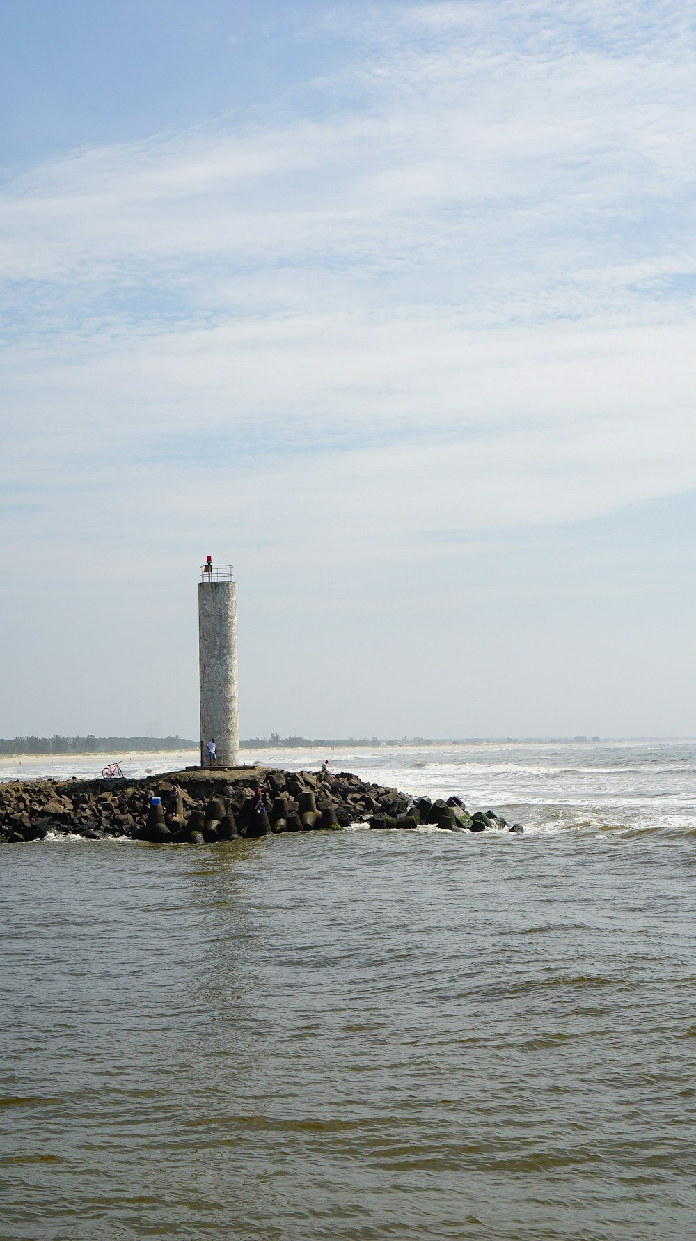 a light house sitting on top of a small island
