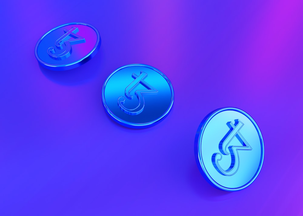 a purple and blue button sitting on top of a purple surface
